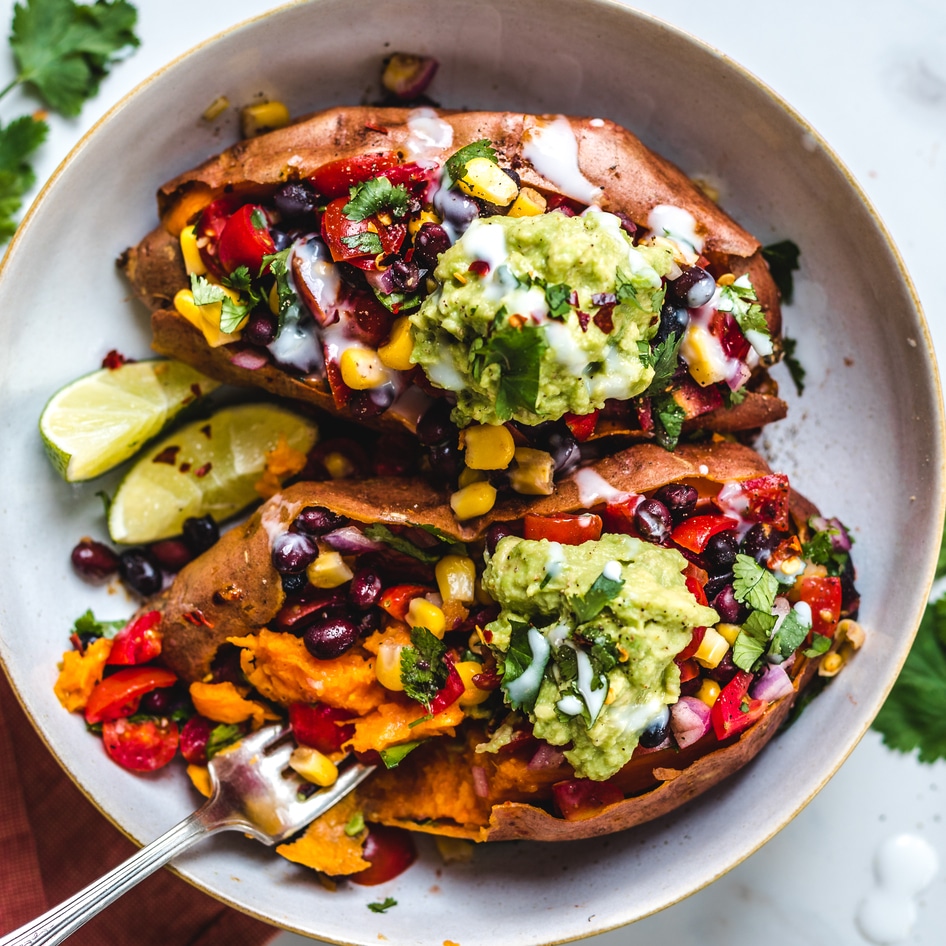 Vegan Black Bean-Stuffed Sweet Potatoes With Coconut Sour Cream and Guacamole