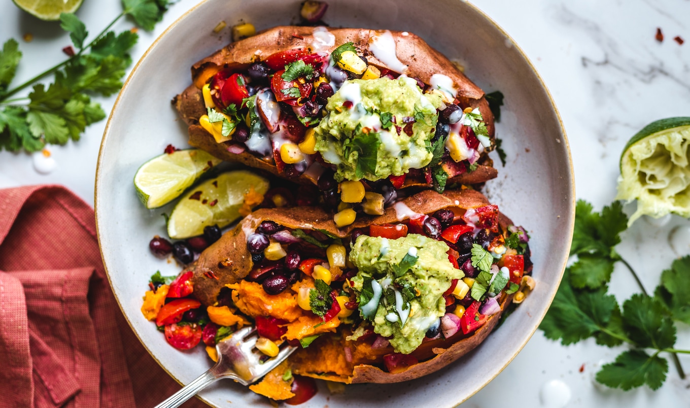 Vegan Black Bean-Stuffed Sweet Potatoes With Coconut Sour Cream and Guacamole