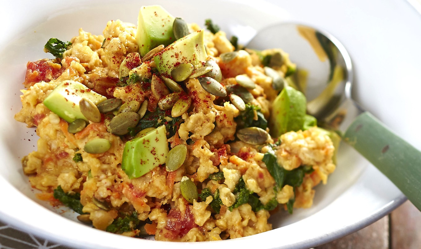 Cheesy Vegan Oatmeal Bowl With Kale and Pumpkin Seeds